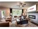 Open-concept living room with a cozy fireplace, large windows for natural light, and stylish furniture at 106 Henley St, Canton, GA 30114