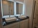 Bathroom with dual sinks, granite countertop, and illuminated mirrors at 1637 Fuma Leaf Way, Mcdonough, GA 30253