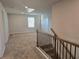 Upstairs hallway featuring carpet floors, white walls, and a wood/metal railing at 1637 Fuma Leaf Way, Mcdonough, GA 30253