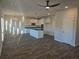 Open floor plan with spacious kitchen featuring white cabinets and an island with a dark countertop at 1637 Fuma Leaf Way, Mcdonough, GA 30253
