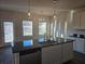 Kitchen island with a sink, stainless steel appliances, and pendant lighting at 1637 Fuma Leaf Way, Mcdonough, GA 30253