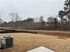 Large, unfenced backyard, offering ample space, and an air conditioning unit at 1641 Fuma Leaf Way, Mcdonough, GA 30253