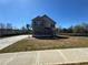 New construction with gray siding and brick accents, complemented by a long driveway and green lawn at 1641 Fuma Leaf Way, Mcdonough, GA 30253