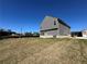 New two-story home with gray siding, a brick foundation, and a spacious side yard at 1641 Fuma Leaf Way, Mcdonough, GA 30253