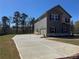 Two-story home with gray siding and a spacious driveway, set in a residential community at 1641 Fuma Leaf Way, Mcdonough, GA 30253