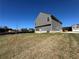 New two-story home with gray siding, a brick foundation, and a spacious side yard and driveway at 1641 Fuma Leaf Way, Mcdonough, GA 30253