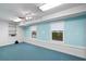 Bright basement area with carpet, white brick accent wall, and two windows at 833 E Morningside Ne Dr, Atlanta, GA 30324