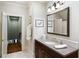 Bathroom with dark wood vanity, double sinks, and warm lighting at 833 E Morningside Ne Dr, Atlanta, GA 30324