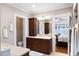 Spacious bathroom featuring double vanities, and an open doorway leading to the primary bedroom at 833 E Morningside Ne Dr, Atlanta, GA 30324