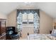 Bedroom features a sloped ceiling, window with patterned curtains, and a cozy seating area at 833 E Morningside Ne Dr, Atlanta, GA 30324