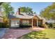 Charming brick home featuring a manicured lawn, brick walkway, and inviting front porch with elegant columns at 833 E Morningside Ne Dr, Atlanta, GA 30324