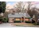 Inviting brick home with a well-maintained lawn, walkway, and dormer windows, showcasing classic charm at 833 E Morningside Ne Dr, Atlanta, GA 30324