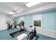 Bright home gym area with white brick accent wall, carpet and windows, featuring various exercise machines at 833 E Morningside Ne Dr, Atlanta, GA 30324