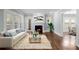 Bright living room with fireplace, hardwood floors, and large windows; a cozy gathering space at 833 E Morningside Ne Dr, Atlanta, GA 30324