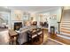 Open-concept living room with hardwood floors, fireplace, and seamless flow to the dining area at 833 E Morningside Ne Dr, Atlanta, GA 30324