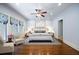 Serene bedroom with hardwood floors, neutral decor, and custom window treatment at 833 E Morningside Ne Dr, Atlanta, GA 30324