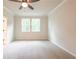 Bedroom with plush carpeting, neutral paint, a ceiling fan, and dual windows at 138 Henley St, Canton, GA 30114