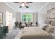 Inviting bedroom with a plush bed, two chairs by the window, ceiling fan, and stylish decor for a tranquil atmosphere at 138 Henley St, Canton, GA 30114