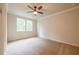 Bedroom with neutral carpet, ceiling fan, and two windows providing natural light at 138 Henley St, Canton, GA 30114