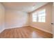 Bright bedroom with hardwood floors and two windows providing natural light at 138 Henley St, Canton, GA 30114