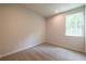Bedroom with neutral paint, carpet, and window overlooking trees at 138 Henley St, Canton, GA 30114