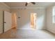 Bedroom with plush carpeting, neutral paint, a ceiling fan, and two entryways at 138 Henley St, Canton, GA 30114