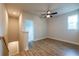 Bedroom with neutral paint, a ceiling fan, hardwood floors, and a window at 138 Henley St, Canton, GA 30114