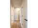 Hallway with wood floors and multiple access doors at 138 Henley St, Canton, GA 30114