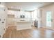 Well-lit kitchen featuring white cabinets, stainless appliances, and island with breakfast bar at 138 Henley St, Canton, GA 30114
