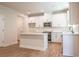 Modern kitchen with island, stainless appliances, sleek white cabinets and hardware at 138 Henley St, Canton, GA 30114