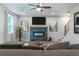 Inviting living room featuring a sleek fireplace, ceiling fan and hardwood floors at 138 Henley St, Canton, GA 30114
