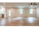 Spacious living room with hardwood floors, natural light, and a ceiling fan at 138 Henley St, Canton, GA 30114