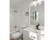 Bright bathroom features a white vanity, updated fixtures, and a bathtub with shower at 708 Martin Rd, Stone Mountain, GA 30088
