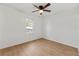 Cozy bedroom featuring wood floors, ceiling fan, and natural light from the window at 708 Martin Rd, Stone Mountain, GA 30088