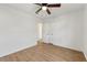 A well-lit bedroom with light wood floors, a ceiling fan, and a closet at 708 Martin Rd, Stone Mountain, GA 30088