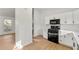 Well-designed kitchen with white cabinets, quartz countertops, and stainless steel appliances at 708 Martin Rd, Stone Mountain, GA 30088