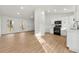 Bright open-concept living space featuring modern kitchen with white cabinets and hardwood flooring throughout at 708 Martin Rd, Stone Mountain, GA 30088