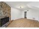 Living room showcasing a stone fireplace, wood floors, and an open doorway at 708 Martin Rd, Stone Mountain, GA 30088