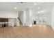 Open-concept living space featuring modern staircase, hardwood flooring, and lots of natural light at 708 Martin Rd, Stone Mountain, GA 30088