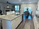 Open-concept kitchen featuring granite countertops, island, and seamless flow to dining area at 5257 Shorthorn Way, Powder Springs, GA 30127