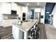 Bright kitchen with granite counters, stainless appliances, and a large island with barstool seating at 5257 Shorthorn Way, Powder Springs, GA 30127