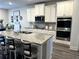 Modern kitchen boasts granite counters, stainless appliances, and stylish island seating at 5257 Shorthorn Way, Powder Springs, GA 30127
