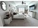 Elegant main bedroom with a tray ceiling, stylish furniture, and ample natural light at 5257 Shorthorn Way, Powder Springs, GA 30127