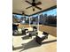 Covered patio featuring comfortable seating, ceiling fans, and outdoor living space at 5257 Shorthorn Way, Powder Springs, GA 30127