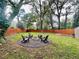 Inviting backyard with a fire pit, Adirondack chairs, garden beds, and a wooden fence at 91 Morris Brown Sw Dr, Atlanta, GA 30314