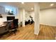 Well-lit basement with hardwood flooring, a dedicated home office space, and fitness equipment setup at 91 Morris Brown Sw Dr, Atlanta, GA 30314