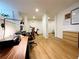 Finished basement with hardwood floors, featuring a home office area with a desk and exercise equipment at 91 Morris Brown Sw Dr, Atlanta, GA 30314