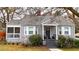 Charming single-story home with a screened-in porch, gray brick, and updated landscaping at 91 Morris Brown Sw Dr, Atlanta, GA 30314