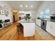 Bright kitchen with an island, granite countertops, modern appliances, and hardwood floors at 91 Morris Brown Sw Dr, Atlanta, GA 30314
