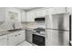 Well-lit kitchen boasts stainless steel refrigerator and a modern gas range at 5400 Roswell Rd # C3, Atlanta, GA 30342